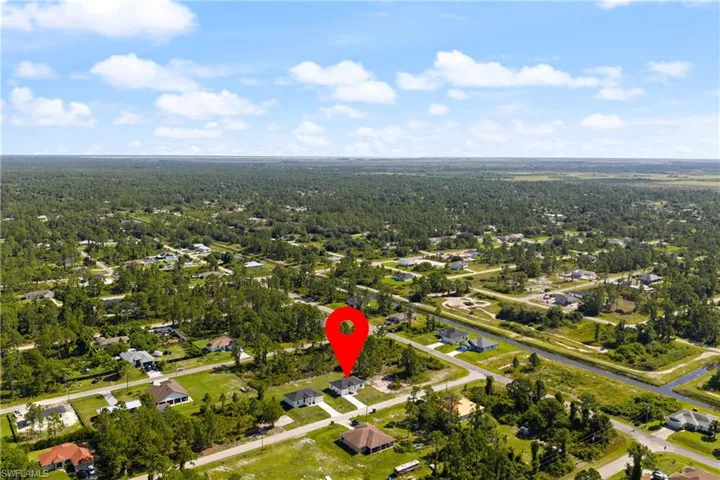 Aerial view of property's location featuring nearby suburban area