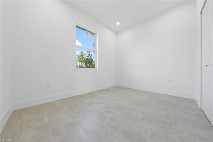 Empty room featuring recessed lighting and baseboards