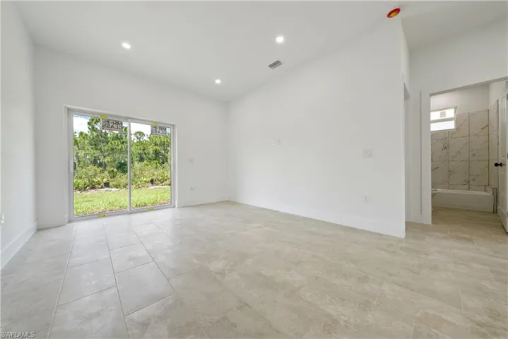 Unfurnished room with plenty of natural light and recessed lighting