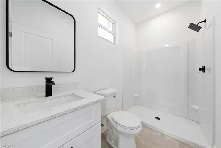 Full bath with vanity and a stall shower