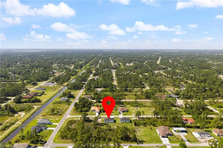Aerial overview of property's location featuring nearby suburban area