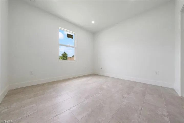 Spare room featuring recessed lighting and baseboards