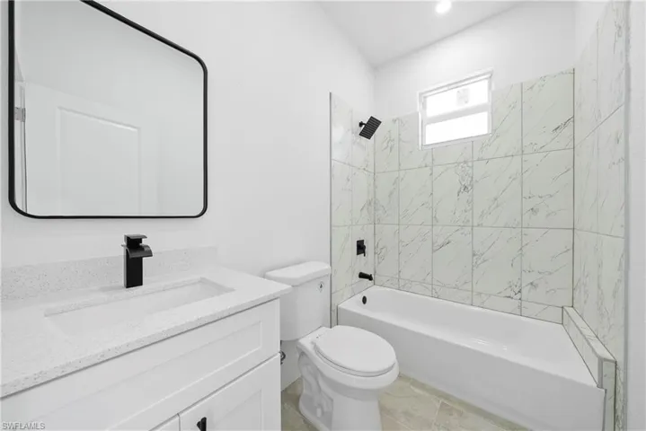 Full bath with bathing tub / shower combination and vanity