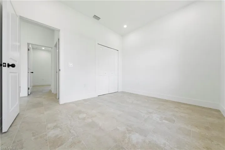 Unfurnished bedroom featuring recessed lighting and a closet