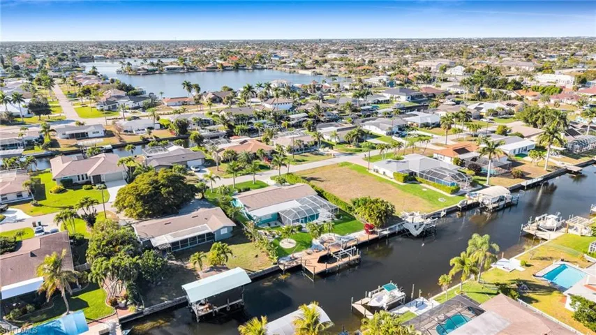 Aerial view of residential area featuring a nearby body of water