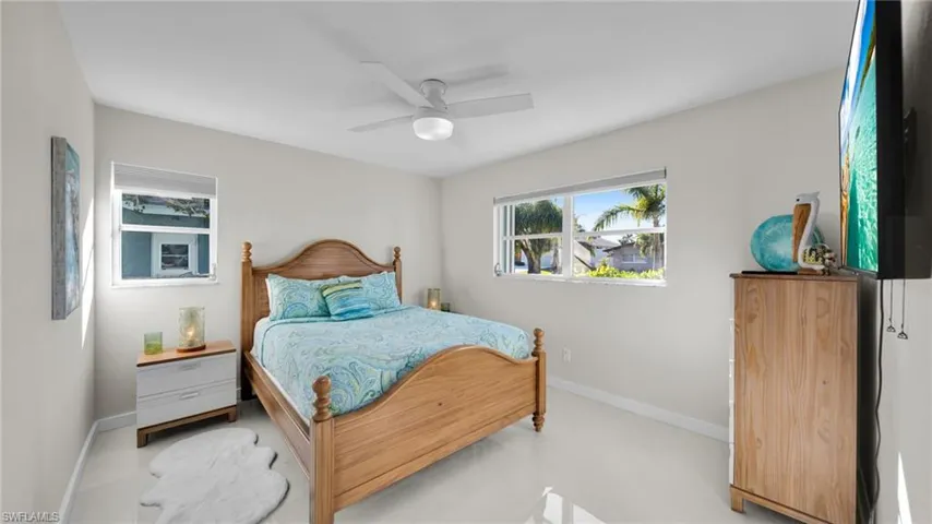 Bedroom featuring ceiling fan and baseboards