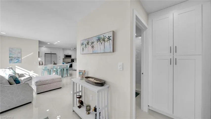 Hall featuring recessed lighting and light tile patterned flooring