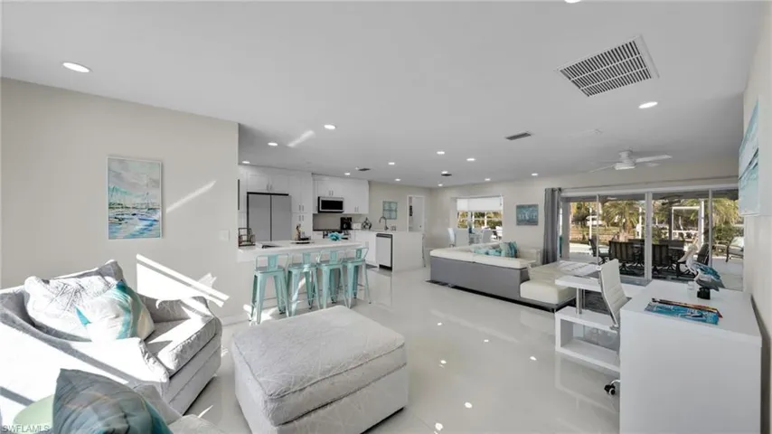 Living area with recessed lighting and ceiling fan