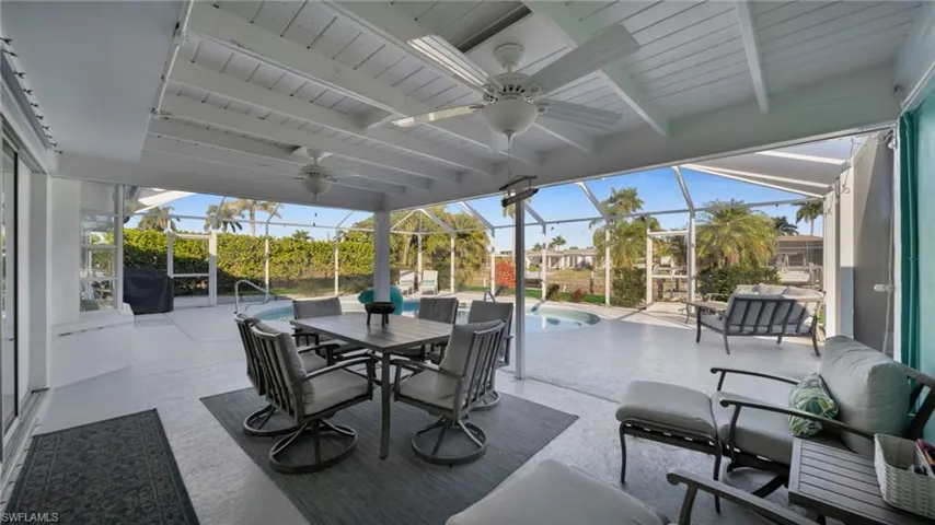 Sunroom / solarium with a patio, ceiling fan, outdoor dining area, and healthy amount of natural light