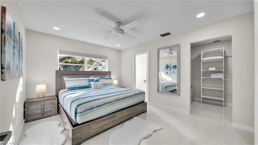 Bedroom featuring a walk in closet, a ceiling fan, and recessed lighting
