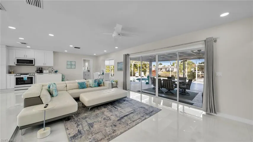 Living area featuring recessed lighting, a sunroom, and a ceiling fan