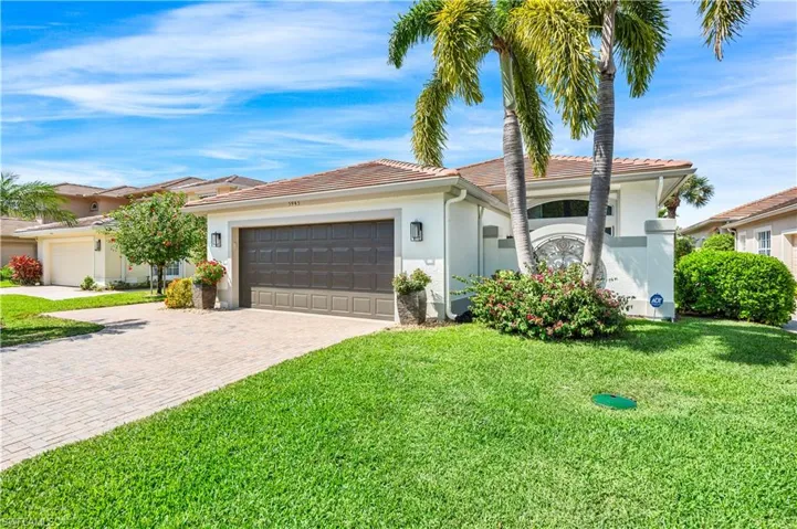 View of front of home featuring a front lawn and a garage