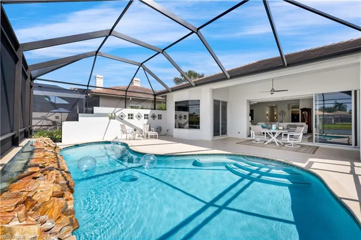 View of pool featuring ceiling fan, a lanai, and a patio