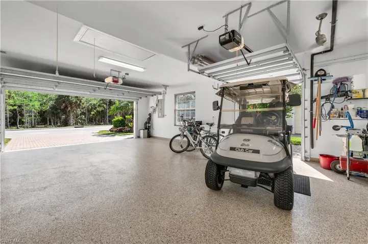 Garage with electric panel and a garage door opener
