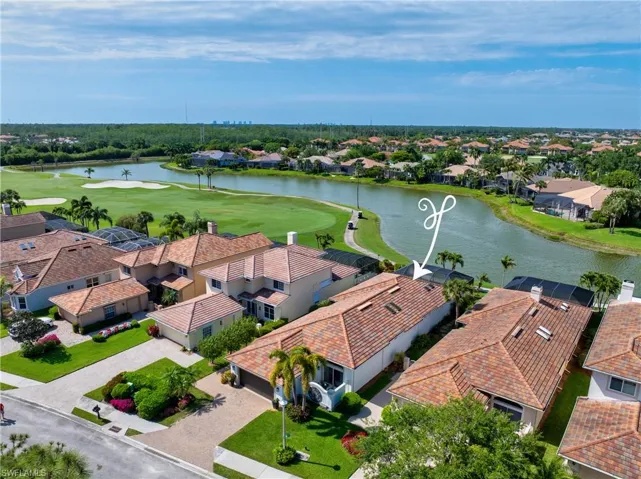 Birds eye view of property with a water view