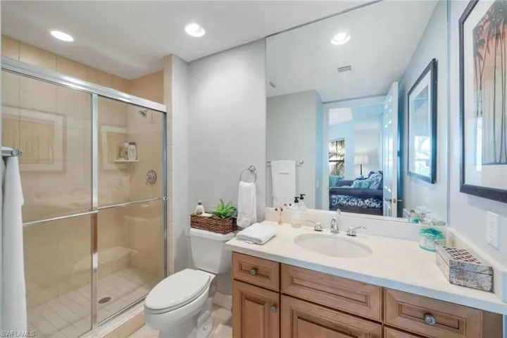 En suite bathroom featuring walk in shower and large vanity
