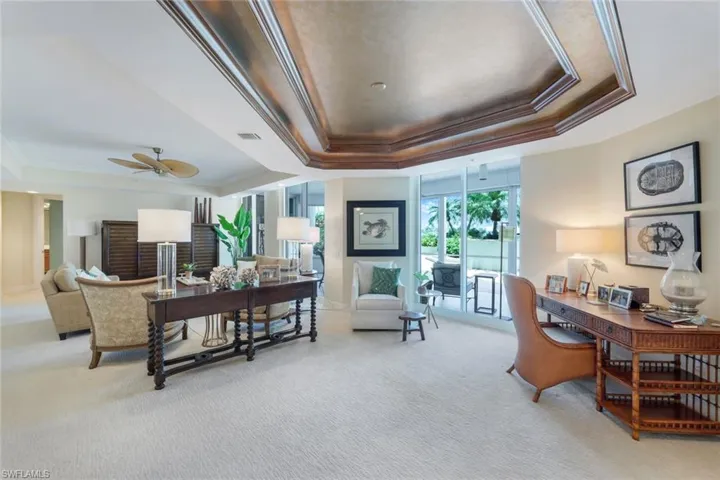 Office area with raised tray ceiling, and crown molding. Sometimes used as formal Dining area.