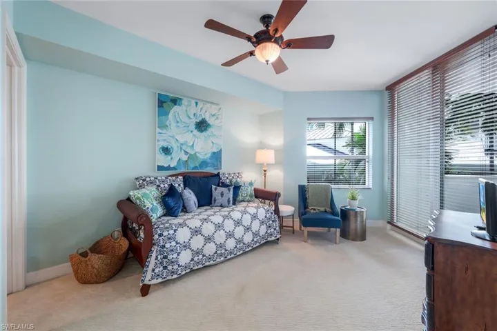Guest bedroom with carpet & ceiling fan, access to terrace