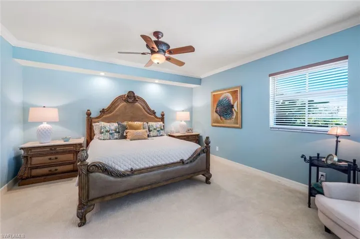 Bedroom featuring ceiling fan and ornamental molding
