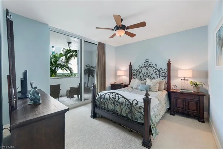Guest bedroom with ceiling fan and access to private lanai