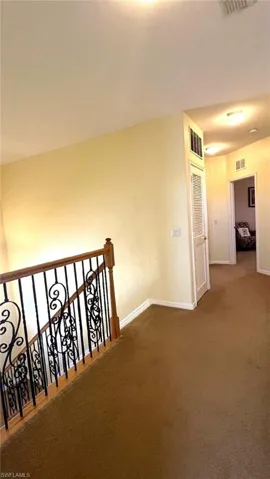 Hall featuring carpet flooring