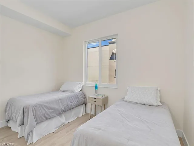 Bedroom with light wood-type flooring and baseboards