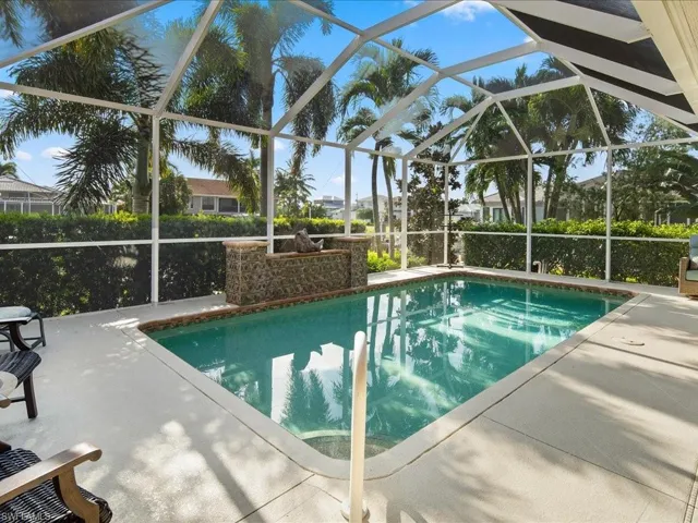 View of swimming pool with a lanai and a patio area