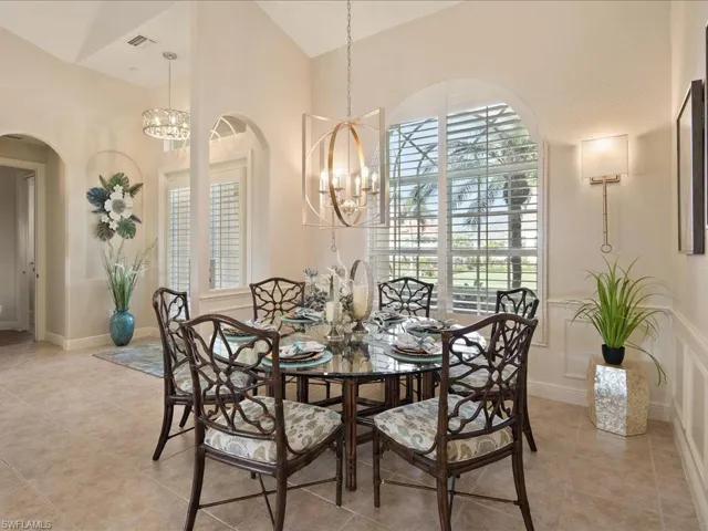 Dining space featuring high vaulted ceiling, a chandelier, and light tile patterned flooring