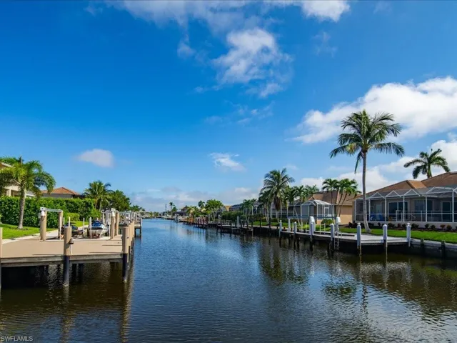 Dock area featuring glass enclosure and a water view