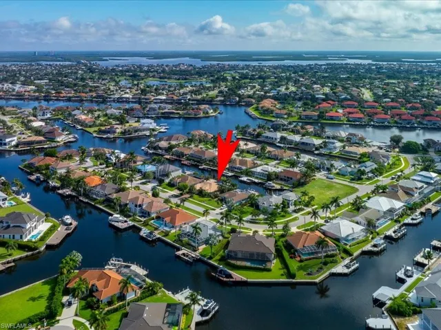 Birds eye view of property with a water view