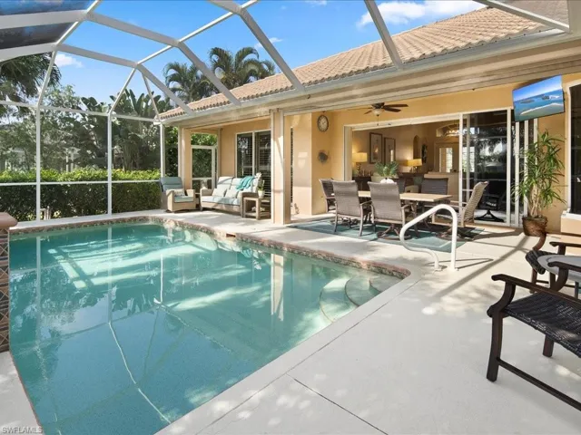 View of swimming pool featuring a lanai, outdoor lounge area, ceiling fan, and a patio area