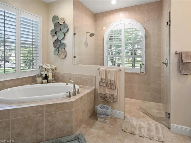 Bathroom featuring plus walk in shower and tile patterned floors