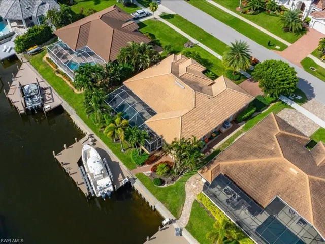 Birds eye view of property with a water view