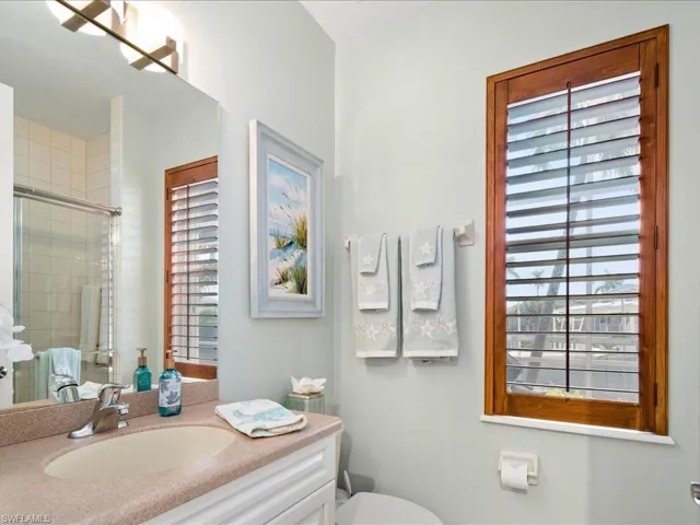 Bathroom with vanity, toilet, and walk in shower