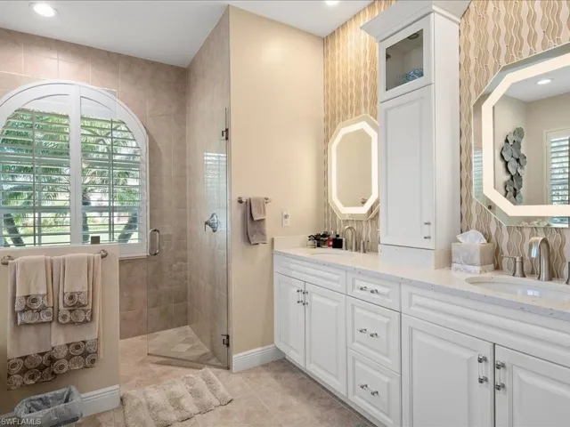 Bathroom with vanity, tile patterned floors, and walk in shower
