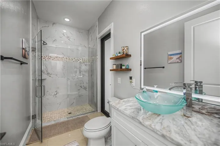 Guest bathroom with a marble finish walk-in shower