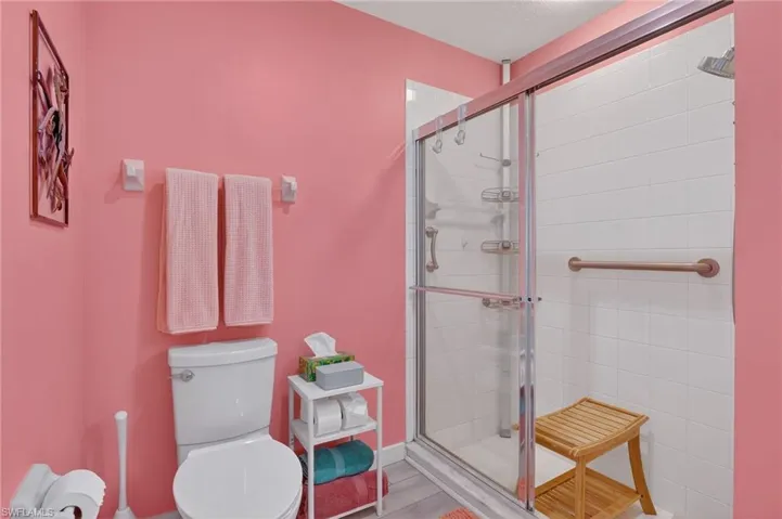 Bathroom featuring a shower stall and tile patterned flooring