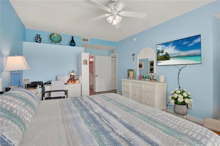 Bedroom with a ceiling fan and baseboards