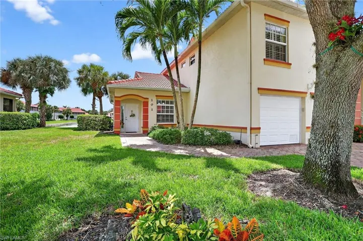 Mediterranean / spanish-style home featuring an attached garage, stucco siding, and a front lawn