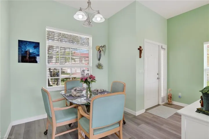 Dining space with wood finished floors and a chandelier