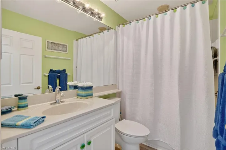 Bathroom featuring vanity and shower / bath combo with shower curtain