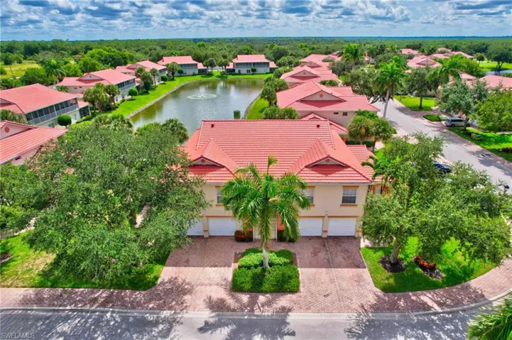 Aerial perspective of suburban area featuring a nearby body of water