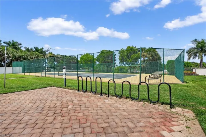 View of property's community with a tennis court