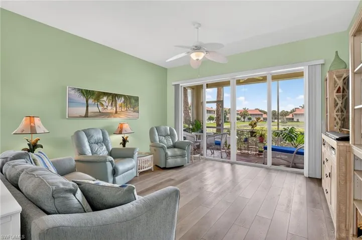 Living area with wood finished floors and a ceiling fan