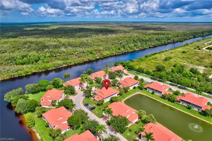 Drone / aerial view of a large body of water and a forest