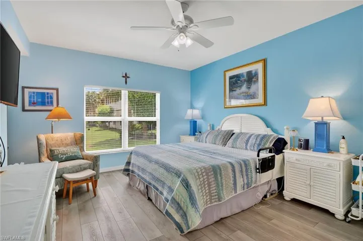 Bedroom with light wood finished floors and a ceiling fan