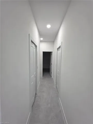 Hallway featuring baseboards