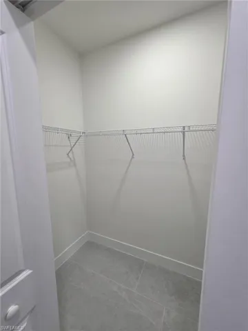 Spacious closet with tile patterned floors
