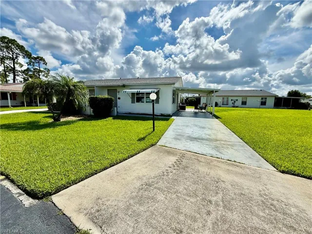 Long driveway with parking for 3 cars.