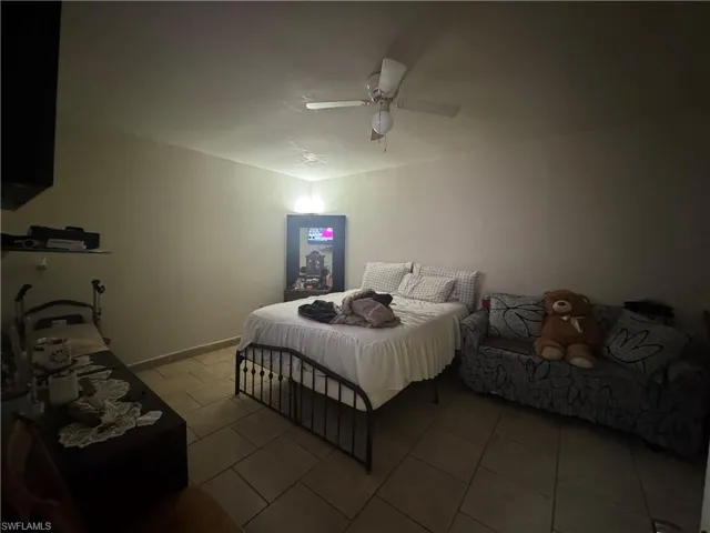 Bedroom featuring a ceiling fan and tile patterned floors